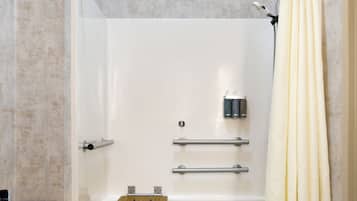 A bathroom with a bathtub, a shower curtain, a towel rack, and a shelf.