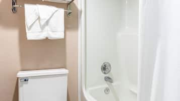 A bathroom with a toilet, a bathtub, and a shower curtain.
