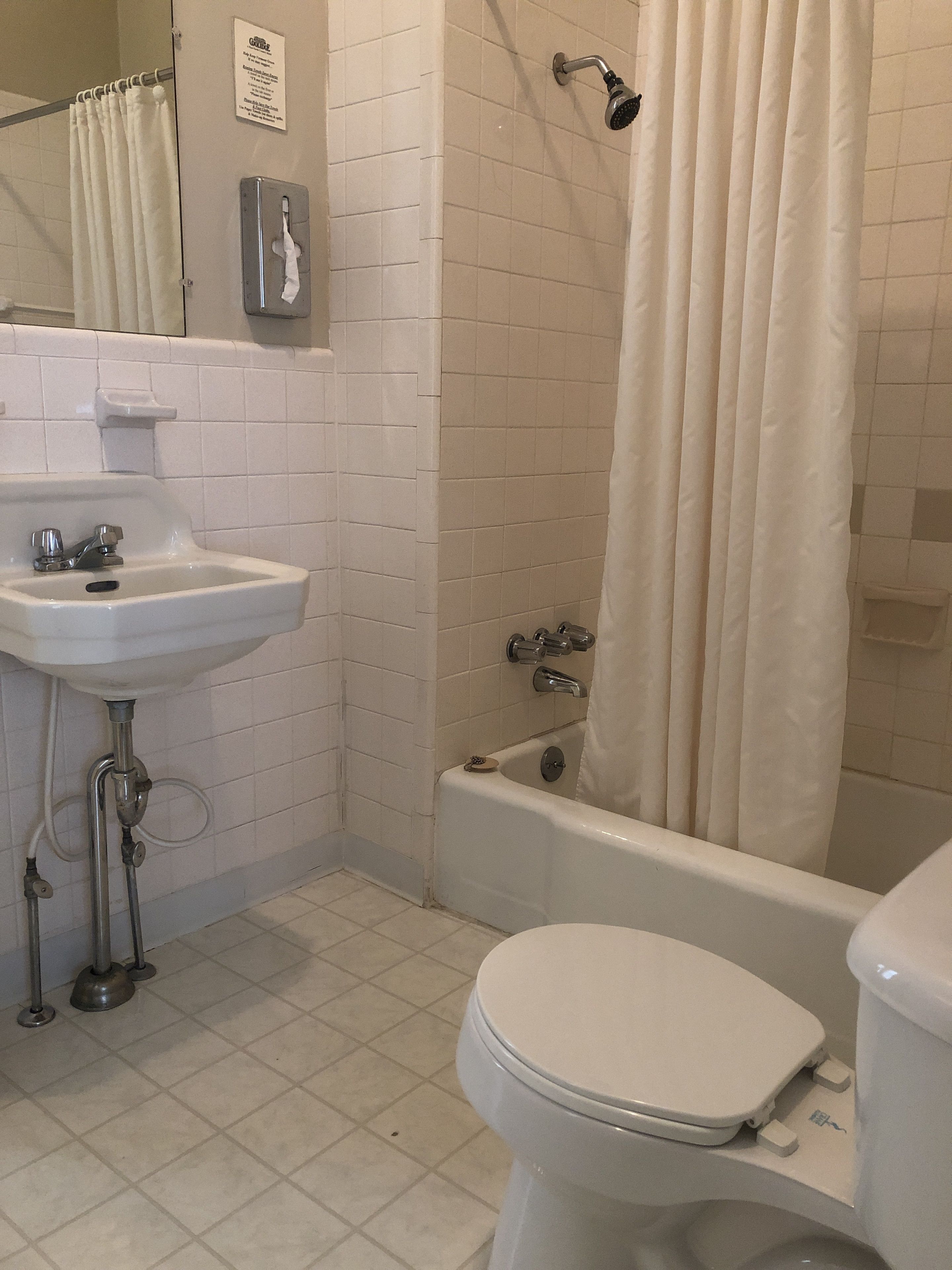 A bathroom with a white sink, toilet, and bathtub.