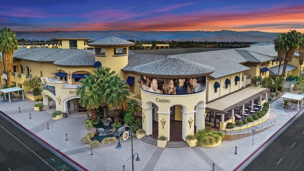 A large, multi-story building with a casino section, featuring a curved entrance and outdoor seating areas. - A Place In The Sun - Adults Only (Palm Springs)