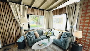A modern living room with a sofa set, a coffee table, and a lamp. - A Place In The Sun - Adults Only (Palm Springs)