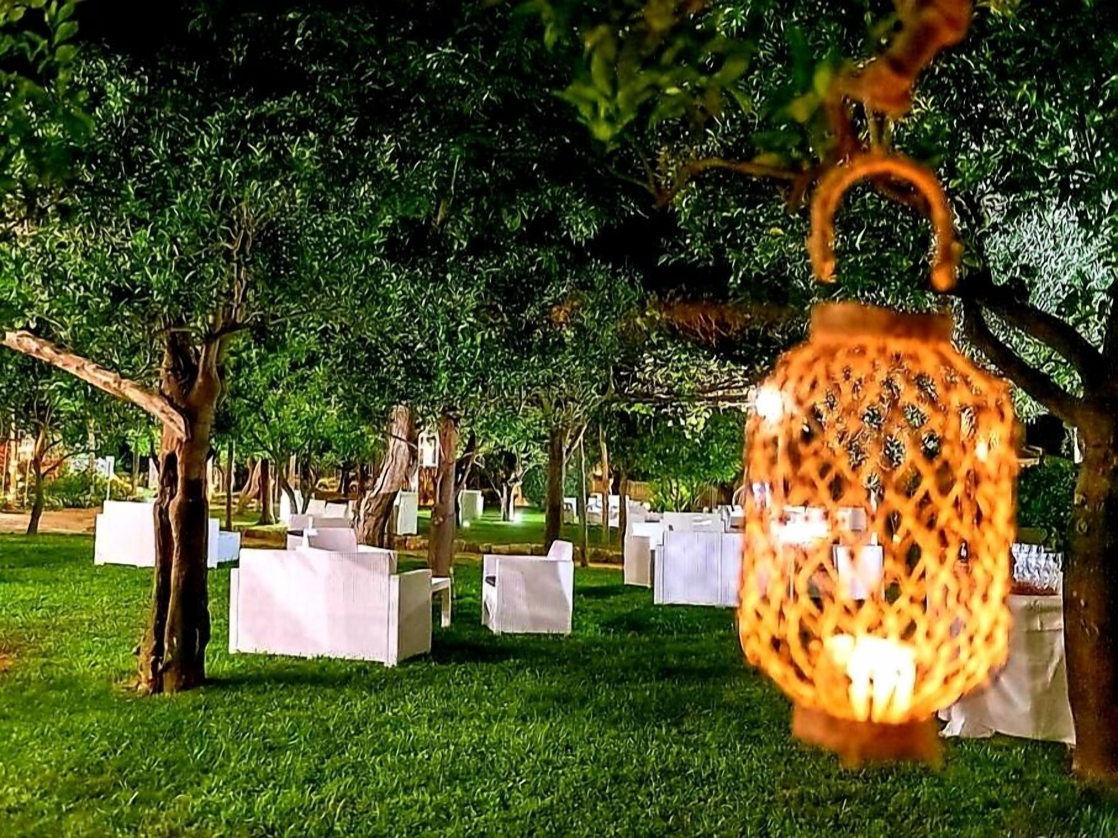 A cemetery with white headstones and a hanging lantern.