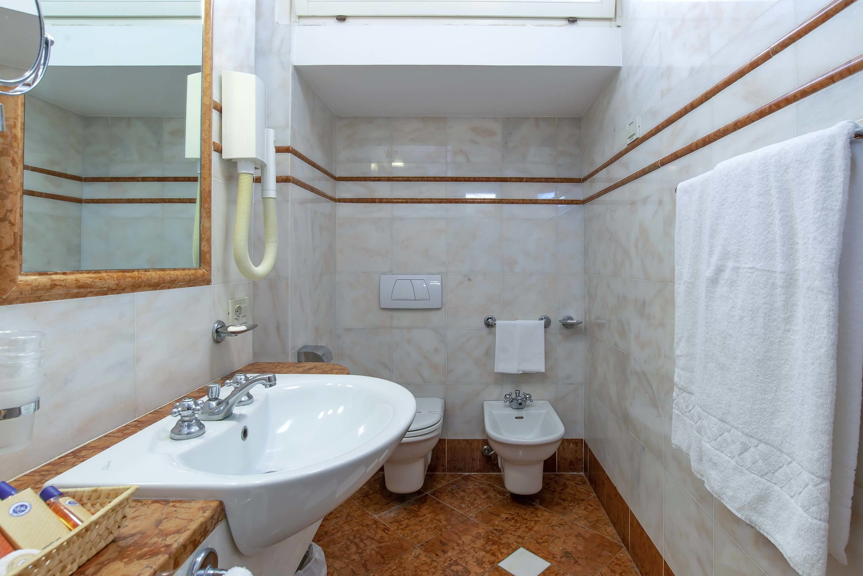 combined shower/bathtub, deep-soaking bathtub, hair dryer, bidet