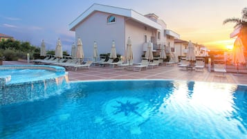 Seasonal outdoor pool, open 8:00 AM to 8:00 PM, pool umbrellas