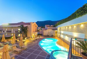 Una piscina al aire libre de temporada, sombrillas