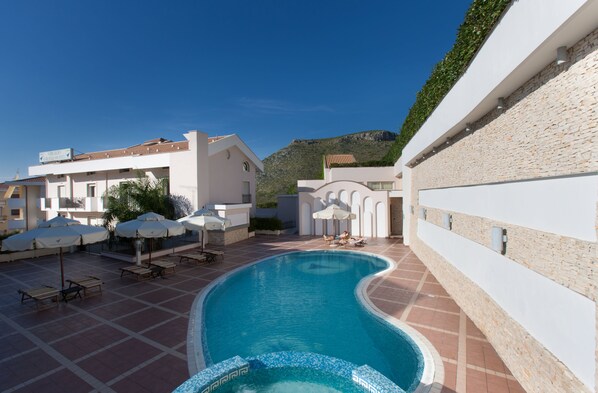 Seasonal outdoor pool, open 8:00 AM to 8:00 PM, pool umbrellas