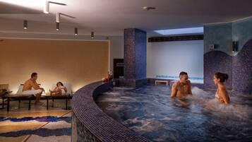 Relax in a serene spa setting with a central hot tub surrounded by comfortable seating.