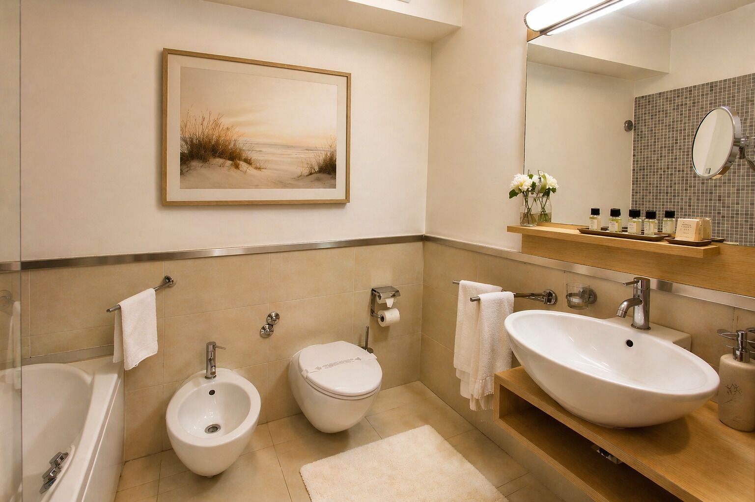 A modern bathroom with a bidet, toilet, bathtub, and a large sink.