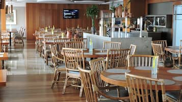 A spacious restaurant with wooden furniture and a modern design.