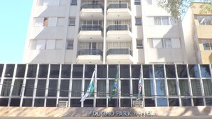 A hotel with a modern facade, multiple balconies, and flags. - Duomo Park Hotel (Curitiba)