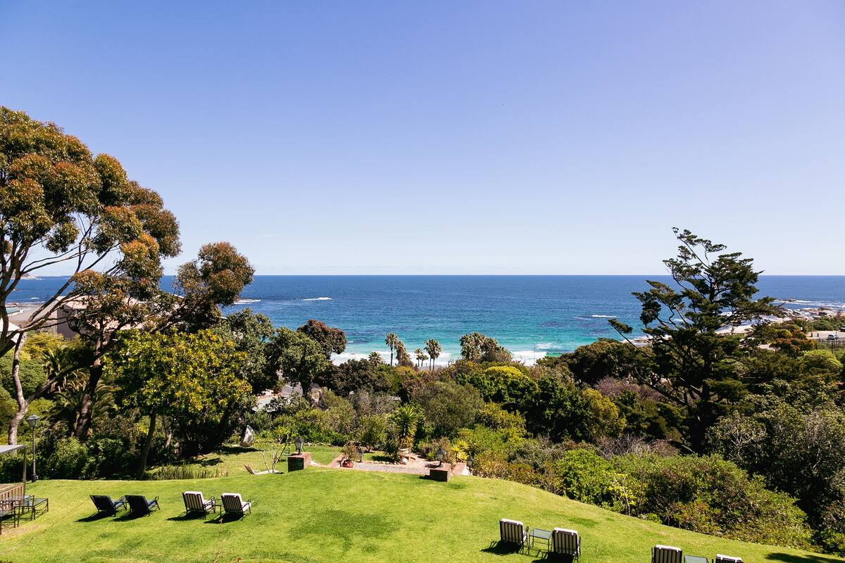 A lush garden with a view of the ocean.
