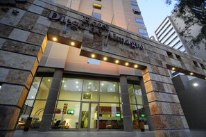 The exterior of Hotel de Madrid with a stone facade and large glass entrance. - Diego De Almagro Calama (Calama)