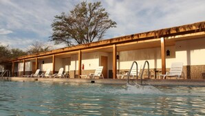 A poolside area with lounge chairs and a covered seating area. - Diego de Almagro San Pedro de Atacama (San Pedro de Atacama)