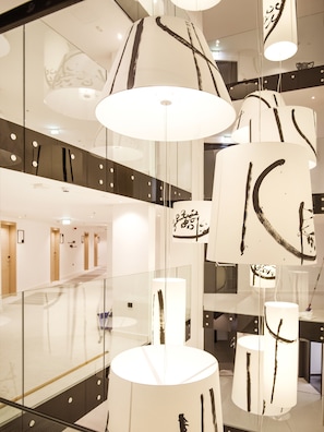 A modern interior with hanging pendant lights featuring abstract black designs.