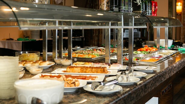 A buffet with various food items and serving utensils. -  RVHotels Tuca (Vielha e Mijaran)