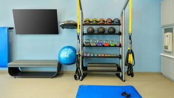 Stay fit on the go with a fully equipped gym featuring a pull-up bar, weights, exercise mat, bench, and exercise ball.