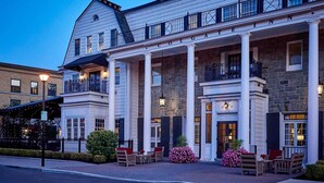 A historic hotel with a grand entrance, large columns, and outdoor seating.