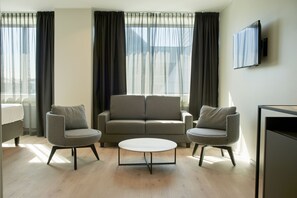 Perhehuone | Ylelliset vuodevaatteet, minibaari, tallelokero huoneessa, työpöytä