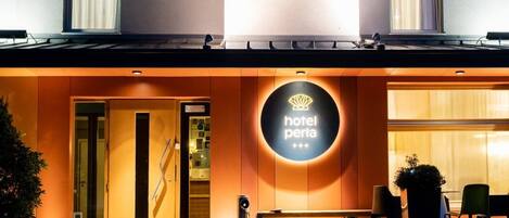 Hotellin sisäänkäynti, jossa on kyltti, jossa lukee ”Hotel Peria”, sekä vastaanottotiski.