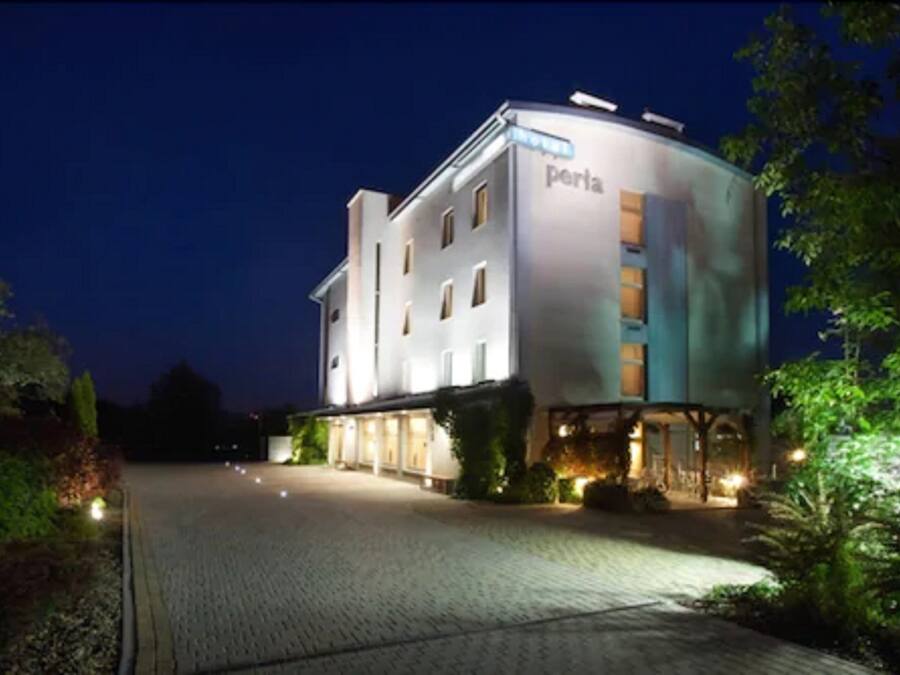 A modern building with the name 'porta' on the facade, featuring a prominent entrance and a well-lit exterior.