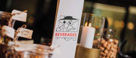 A beverage sign with a graphic of a woman in a hat and the word "BEVERAGES" on a white background.