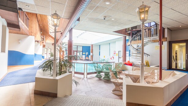 A spacious lobby with a pool, seating areas, and a staircase. - Craigmonie Hotel Inverness by Compass Hospitality (Inverness)