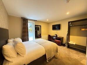 A hotel room with a bed, a desk, a chair, a television, and a wardrobe. - Belvilla Inverness Craigmonie Hotel (Inverness)