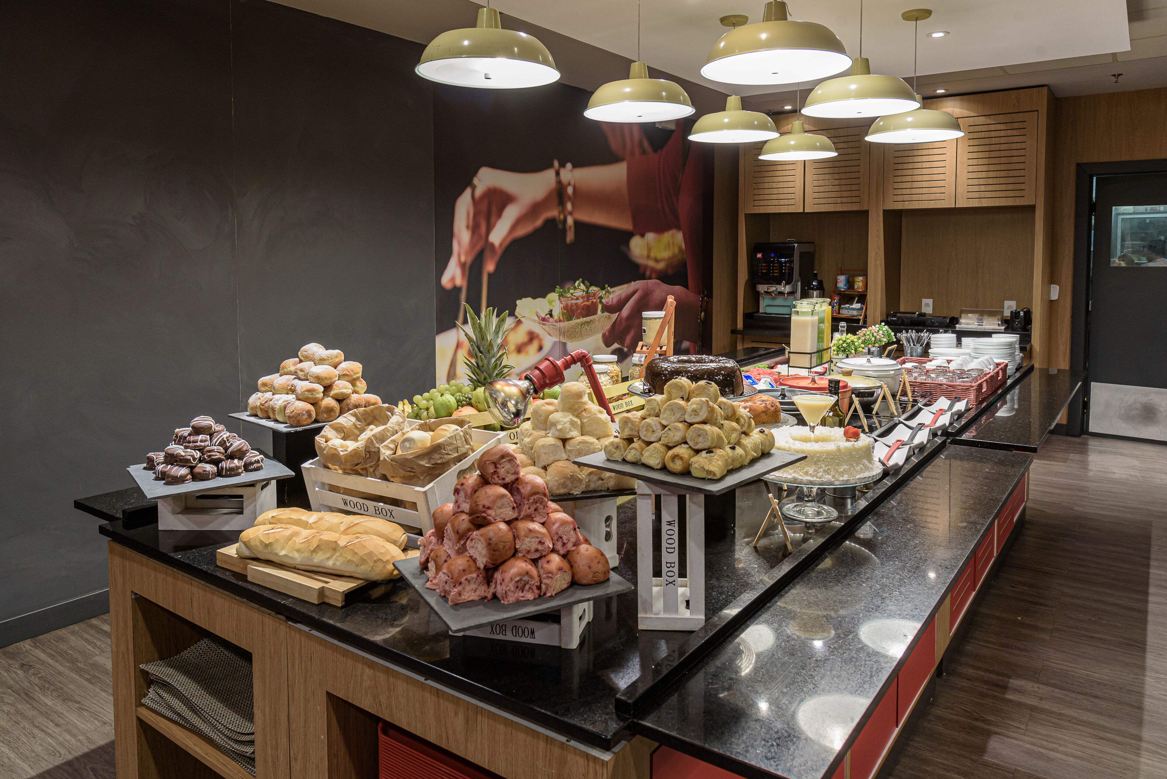 A buffet with various food items and a 'WOOD BOX' sign.