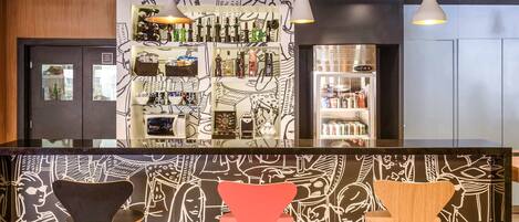 A bar area with a counter, shelves with bottles, and a refrigerator.