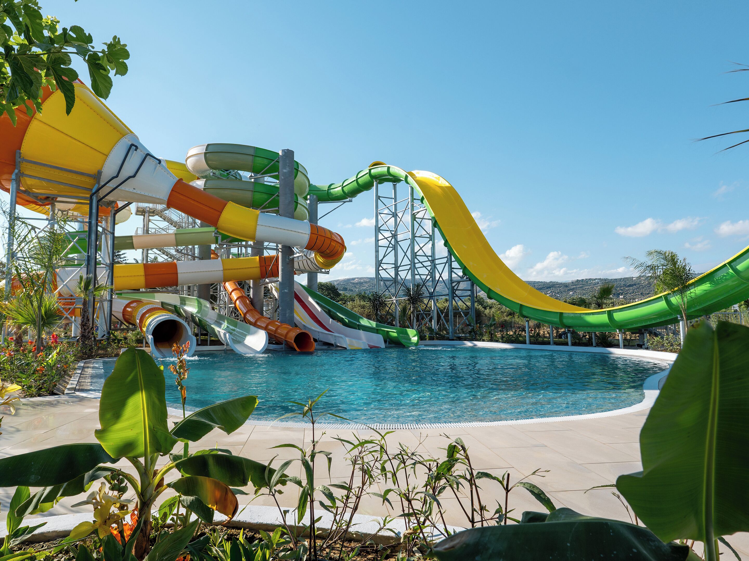 A water park with multiple slides and a pool.