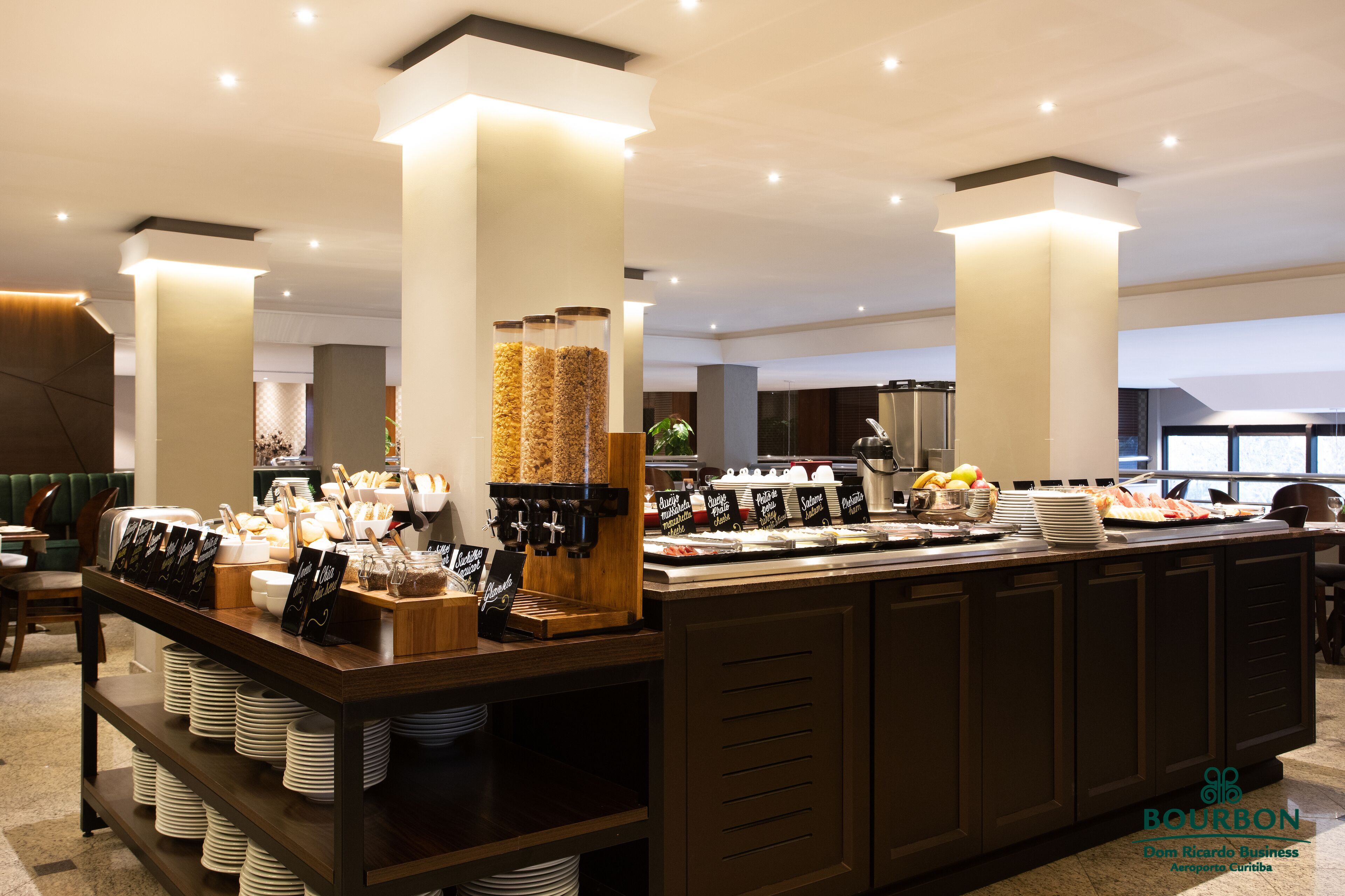 A buffet area with various food items and a coffee station.