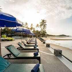 On the beach, white sand, sun-loungers, beach umbrellas