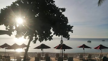 On the beach, sun-loungers, beach umbrellas, beach towels