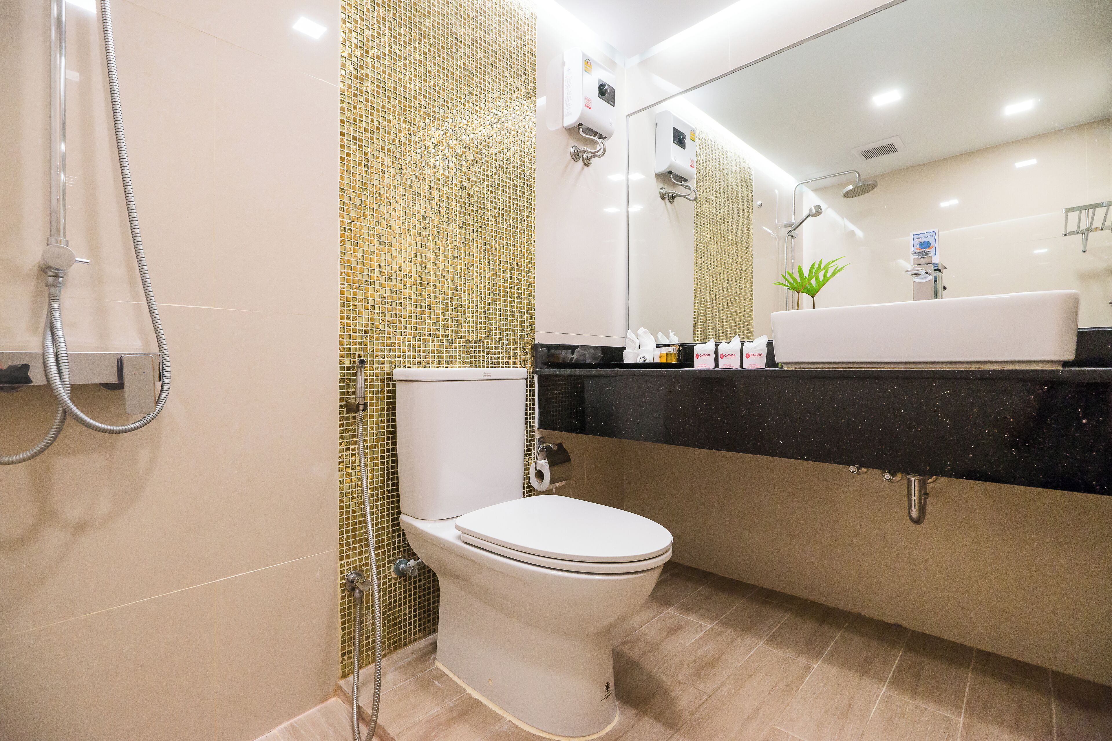 A modern bathroom with a toilet, shower, and sink.