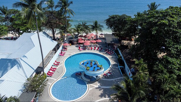 A resort pool area with two pools, lounge chairs, umbrellas, and palm trees. - MATCHA SAMUI RESORT (Koh Samui)