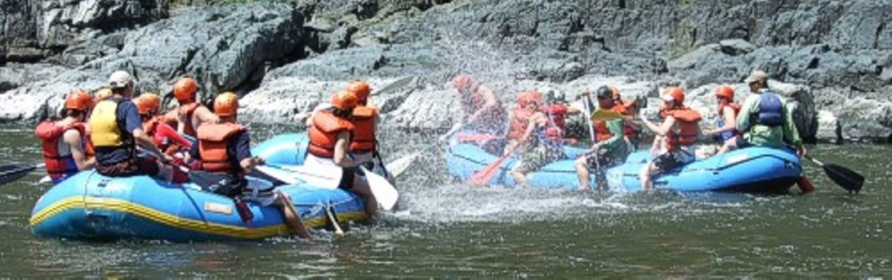 People on inflatable rafts in a river.