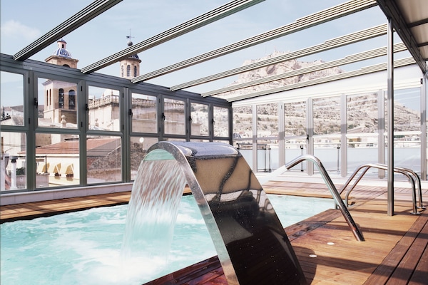 Indoor pool, pool umbrellas, sun loungers