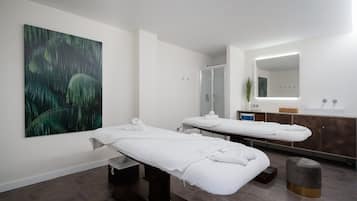 Relax in a serene spa room with a massage table, glass-enclosed shower, and a soothing atmosphere.