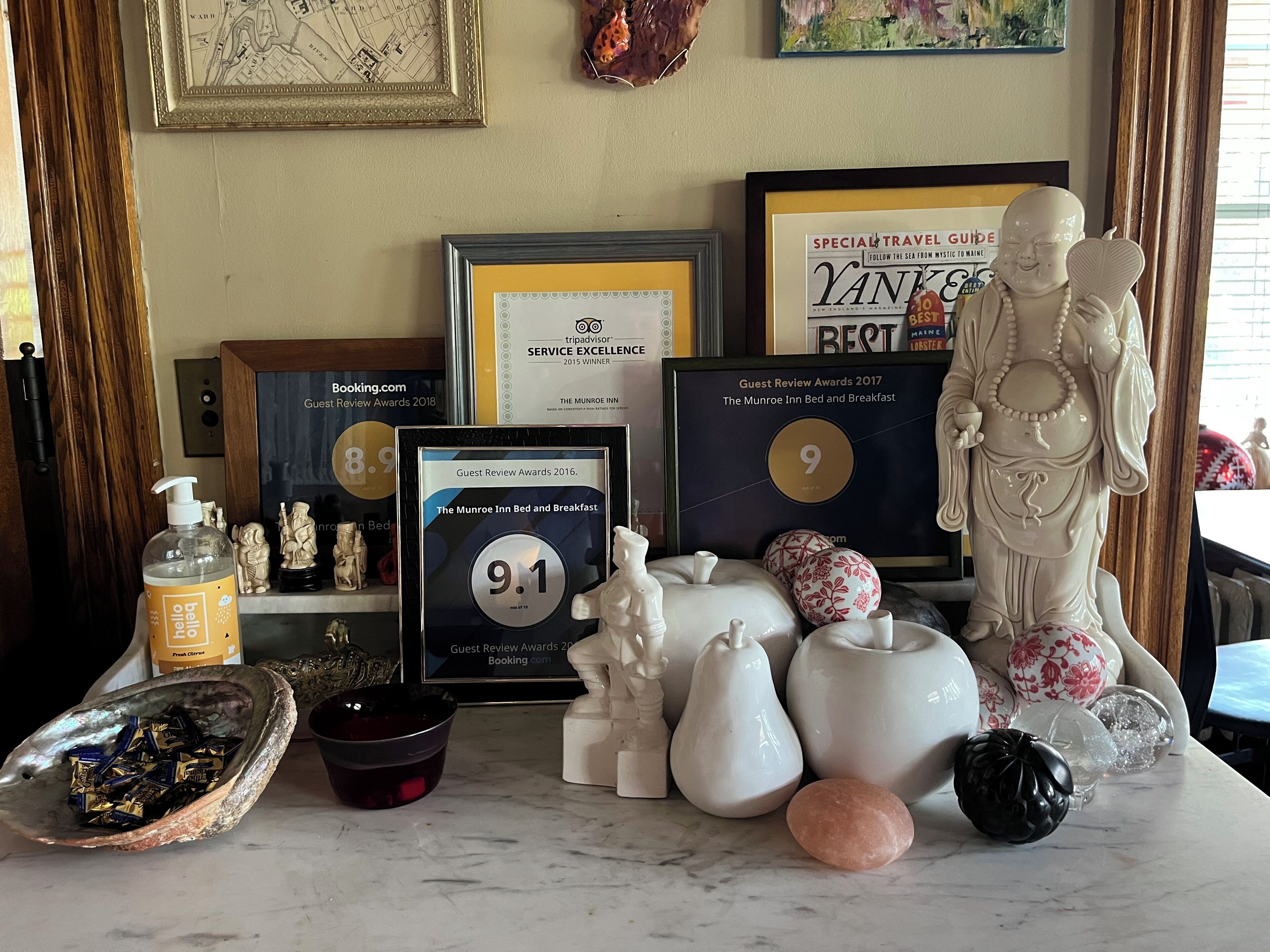 A table with awards, a statue, and various decorative items.