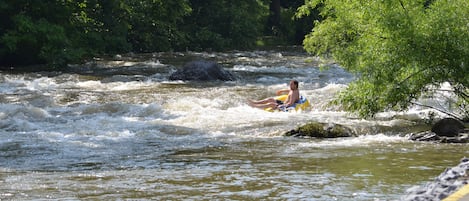 A river with a person in a kayak.