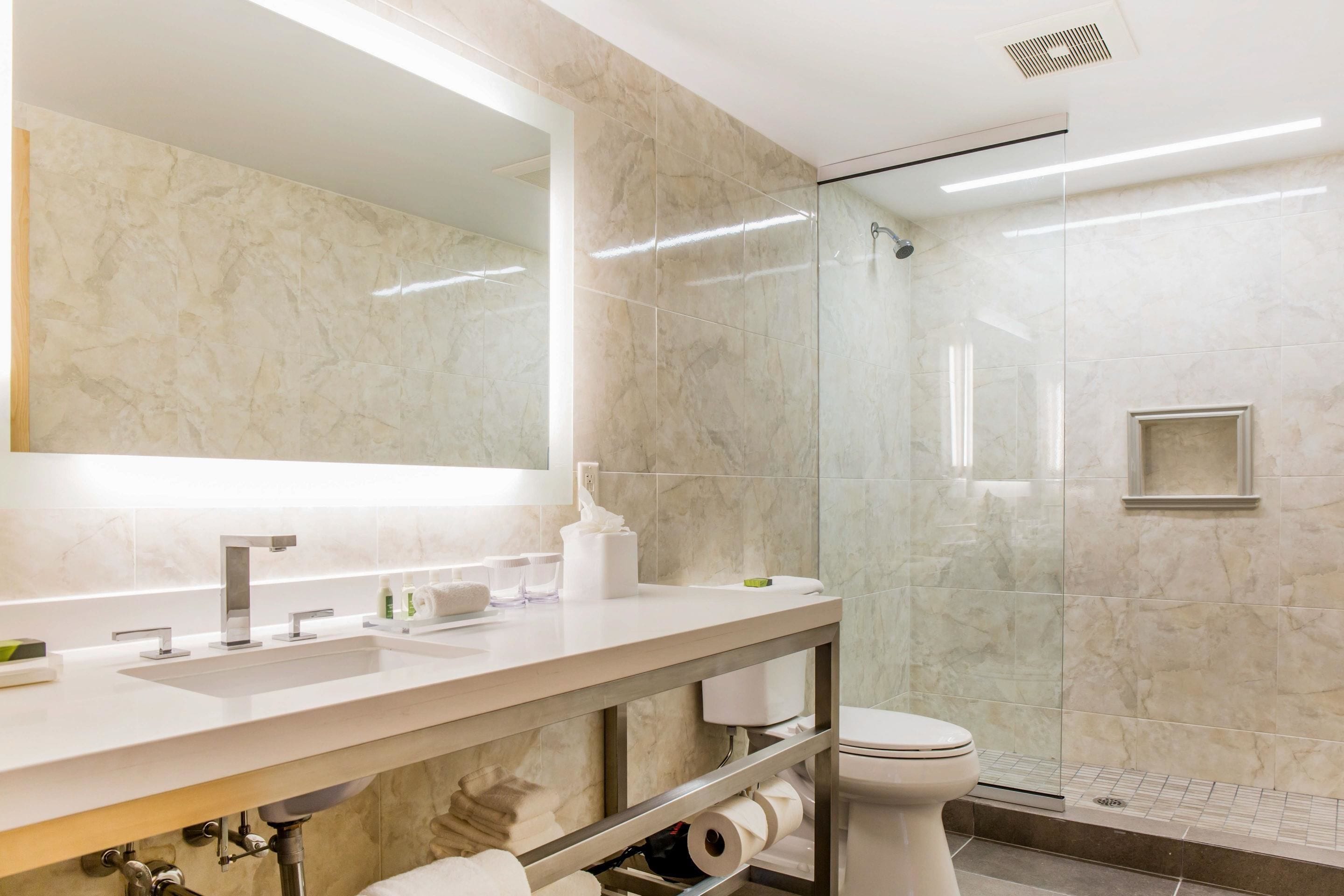 designer toiletries, hair dryer, towels