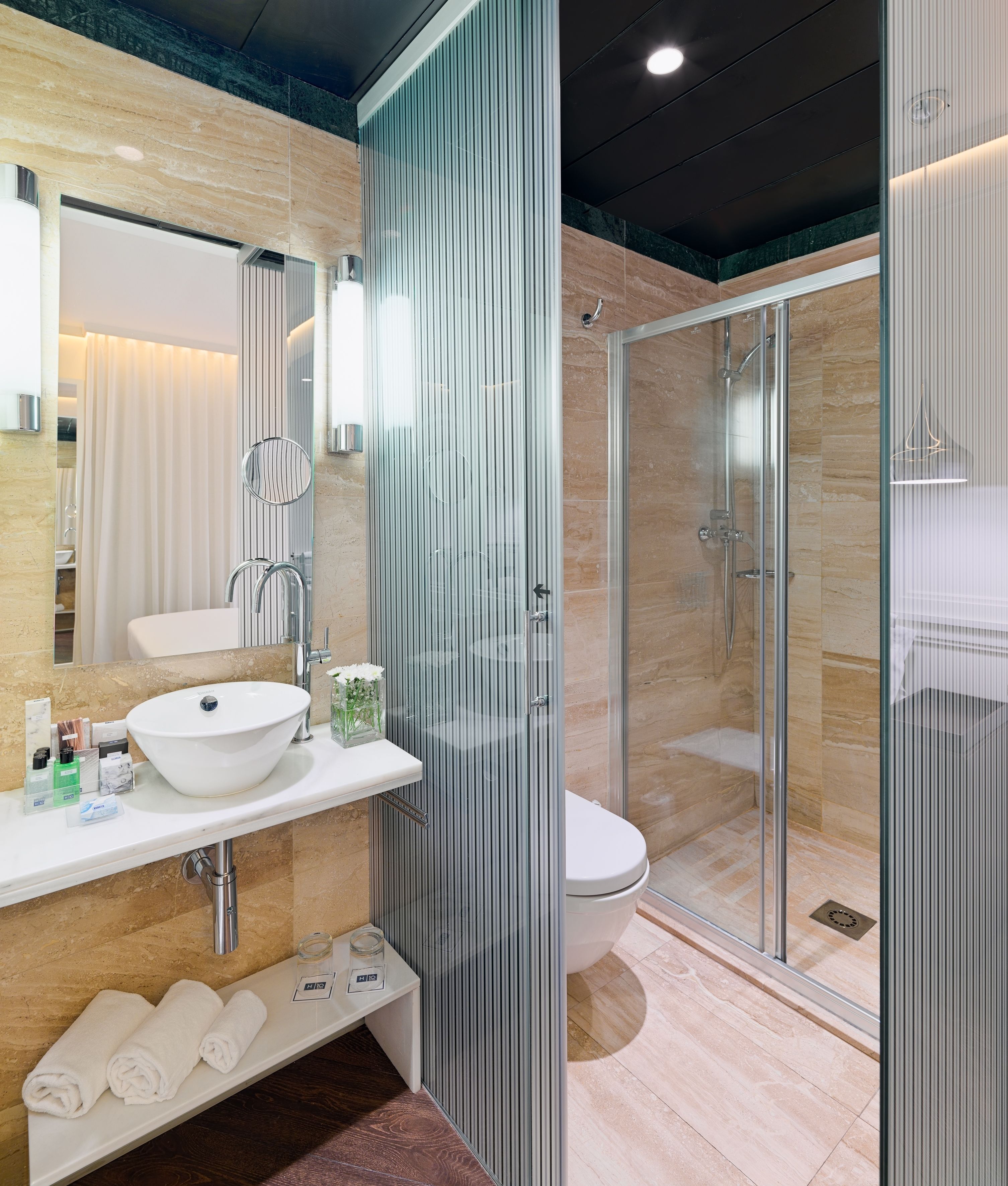 designer toiletries, hair dryer, towels