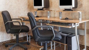 A workspace with two monitors, a keyboard, and two office chairs. - Days Inn by Wyndham Hillsboro TX (Hillsboro)