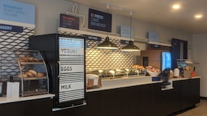 A breakfast station with labeled sections for eggs, milk, yogurt, and hot food. - Holiday Inn Express & Suites Austin Round Rock by IHG (Round Rock)