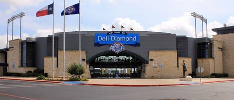 A large building with a sign reading "Dell Diamond".