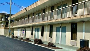 A two-story motel with a flat facade, multiple windows, and a balcony on the upper floor. - Travel Inn Bristol near State St (Bristol)