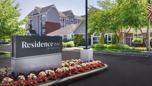 A sign for Residence Inn by Marriott with a landscaped flower bed in front. - Residence Inn by Marriott Poughkeepsie (Poughkeepsie)