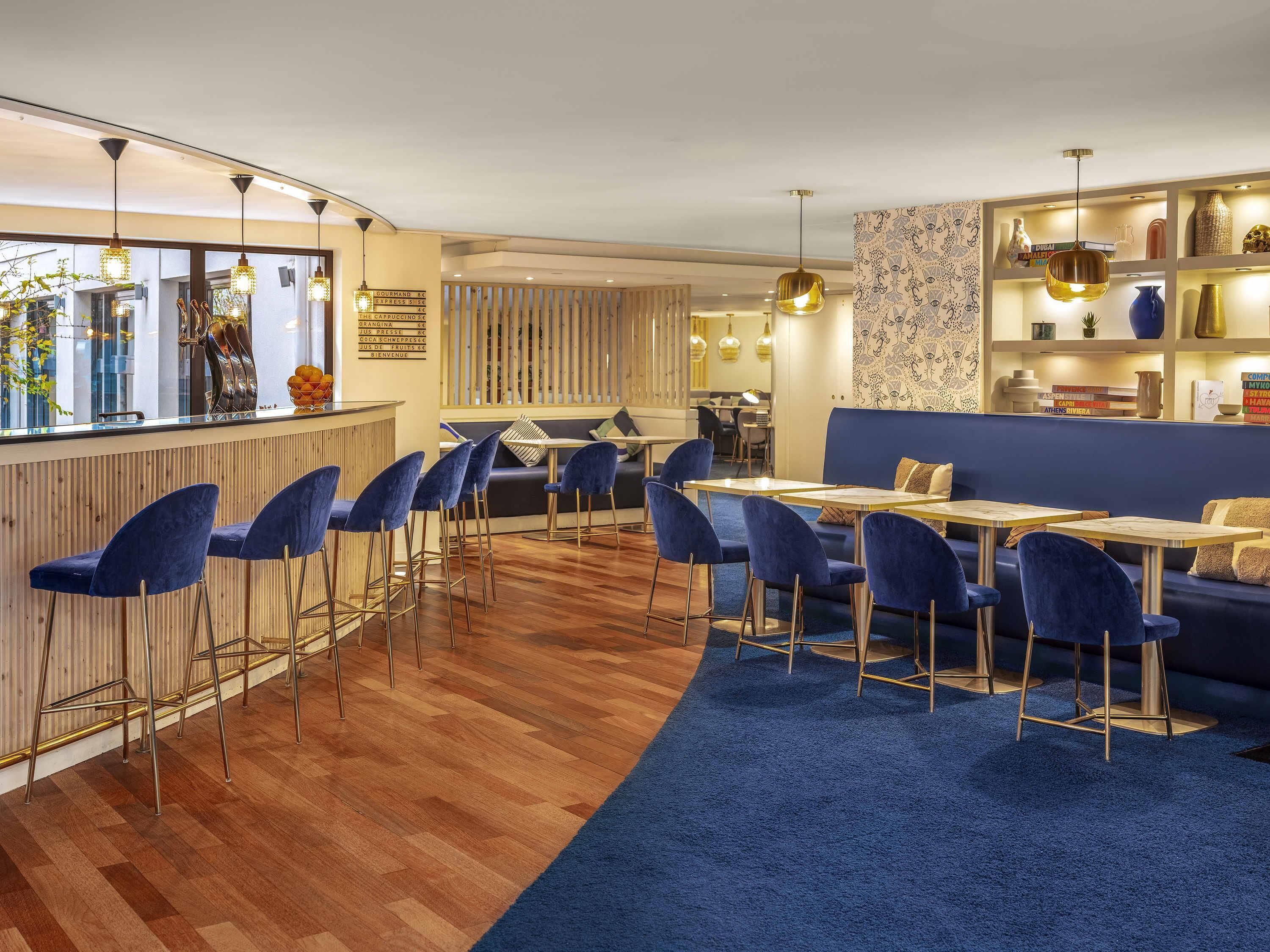 A modern interior with a bar area, seating, and a patterned wall.