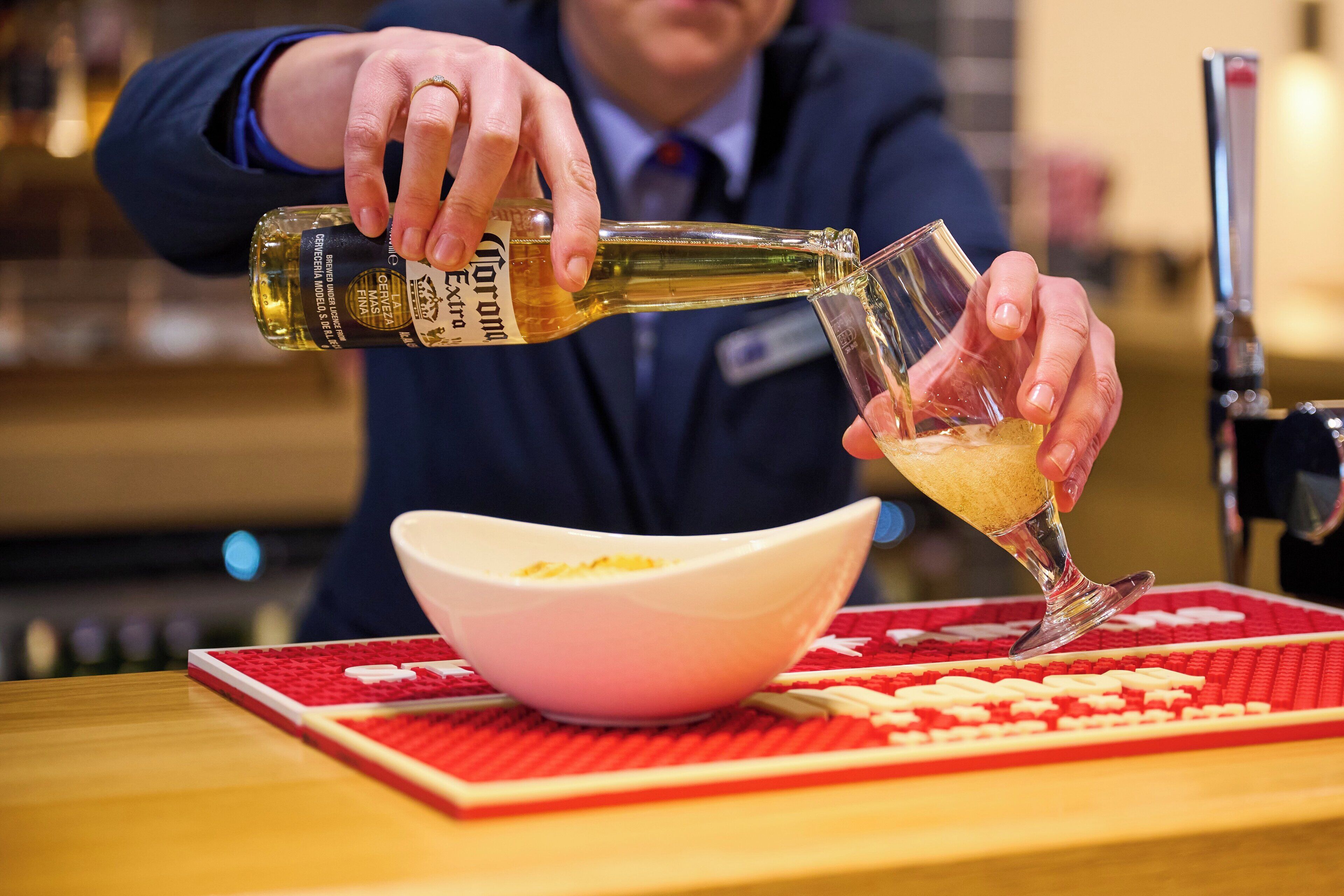 A person pouring a drink into a glass.