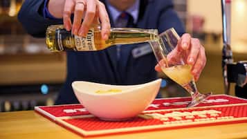 A person pouring a drink into a glass.